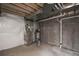 Utility area in the unfinished basement showcasing the furnace, water heater, and other essential mechanical systems at 17600 Rose Heath Ln, Parker, CO 80134
