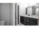 Bright bathroom featuring a double vanity with modern fixtures at 17600 Rose Heath Ln, Parker, CO 80134