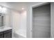 Bathroom featuring a double vanity, bathtub, and shelving at 17600 Rose Heath Ln, Parker, CO 80134