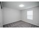 Bedroom with neutral colored walls, gray carpet, and window with white trim at 17600 Rose Heath Ln, Parker, CO 80134