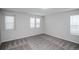 Spacious bedroom with three windows allowing for an abundance of natural light and neutral carpet at 17600 Rose Heath Ln, Parker, CO 80134