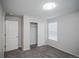 Bedroom with neutral colored walls, gray carpet, closet and white trim at 17600 Rose Heath Ln, Parker, CO 80134