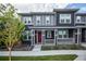 Charming townhouse with a landscaped front yard and a welcoming red front door at 17600 Rose Heath Ln, Parker, CO 80134