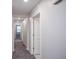 Hallway with gray carpet leading to bedrooms and bathrooms at 17600 Rose Heath Ln, Parker, CO 80134