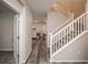 Inviting hallway featuring hardwood floors and a staircase with white banisters at 17600 Rose Heath Ln, Parker, CO 80134