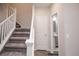 Hallway with staircase, access to a powder room, and durable flooring at 17600 Rose Heath Ln, Parker, CO 80134
