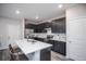 Modern kitchen with sleek dark cabinets, marble countertops, and stainless steel appliances at 17600 Rose Heath Ln, Parker, CO 80134