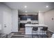 Spacious kitchen with dark cabinets, stainless steel appliances, and a large center island at 17600 Rose Heath Ln, Parker, CO 80134