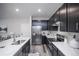 Modern kitchen boasting dark cabinets, stainless steel appliances, and marble countertops at 17600 Rose Heath Ln, Parker, CO 80134