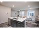 Bright kitchen features white countertops, dark cabinets, and an island with a sink at 17600 Rose Heath Ln, Parker, CO 80134