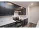 Modern kitchen features stainless steel appliances, gray cabinets, and white subway tile backsplash at 17600 Rose Heath Ln, Parker, CO 80134