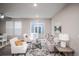 Open-concept living room features modern furniture, large windows, and a ceiling fan at 17600 Rose Heath Ln, Parker, CO 80134