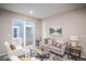 Cozy living room with natural light, neutral furniture, and access to the patio at 17600 Rose Heath Ln, Parker, CO 80134