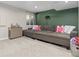 Cozy basement with a comfortable sectional sofa and a stylish bar area, perfect for entertaining guests at 5555 E Briarwood Ave # 1404, Centennial, CO 80122