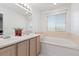 Well-lit bathroom with a double sink vanity and a luxurious soaking tub for a spa-like experience at 5555 E Briarwood Ave # 1404, Centennial, CO 80122