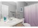 Bathroom with a sink, toilet, cabinet, mirror, and shower featuring a modern purple curtain at 5555 E Briarwood Ave # 1404, Centennial, CO 80122