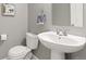 Bathroom featuring a pedestal sink, toilet, and towel rack, accented by neutral paint at 5555 E Briarwood Ave # 1404, Centennial, CO 80122