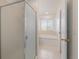 Bathroom featuring a modern glass-enclosed shower, a soaking tub, and sleek fixtures for a contemporary feel at 5555 E Briarwood Ave # 1404, Centennial, CO 80122