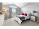 Sunlit bedroom with vaulted ceiling and a large window, complemented by neutral tones and stylish furnishings at 5555 E Briarwood Ave # 1404, Centennial, CO 80122