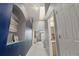 Hallway with an alcove and decorative painting with skylights to two separate rooms at 5555 E Briarwood Ave # 1404, Centennial, CO 80122