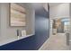 Hallway with an alcove and decorative painting leading to a bedroom with lots of natural light at 5555 E Briarwood Ave # 1404, Centennial, CO 80122
