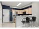 Contemporary kitchen with stainless steel refrigerator and breakfast bar at 5555 E Briarwood Ave # 1404, Centennial, CO 80122