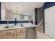 Open kitchen area with stainless steel dishwasher, sink, and view of living room and staircase at 5555 E Briarwood Ave # 1404, Centennial, CO 80122