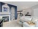 Inviting living room with fireplace, sofa, and charming blue accent wall at 5555 E Briarwood Ave # 1404, Centennial, CO 80122