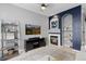 Living room with fireplace, TV, shelving, and cozy decor at 5555 E Briarwood Ave # 1404, Centennial, CO 80122