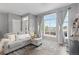 Bright living room with a comfortable sofa, large window, and stylish rug at 5555 E Briarwood Ave # 1404, Centennial, CO 80122