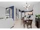 Open concept living and dining space with modern lighting fixtures at 5555 E Briarwood Ave # 1404, Centennial, CO 80122