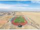 A high school football field and stadium as seen from an aerial view in this neighborhood at 1079 Larkspur Dr, Erie, CO 80516