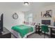 Bright bedroom featuring a work space with desk, chair, and wall art at 1079 Larkspur Dr, Erie, CO 80516