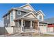 Charming two-story home featuring a covered porch, stone accents, and a two-car garage at 1079 Larkspur Dr, Erie, CO 80516