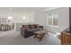 Upstairs living room with a comfortable gray sofa and plush gray carpet at 1079 Larkspur Dr, Erie, CO 80516