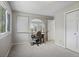 Bedroom with neutral carpet, two windows, white trim, a desk, and a closet at 15207 W Ellsworth Pl, Golden, CO 80401