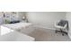 Bedroom features a bed with floral sheets, a side table, and a white modern chair at 15207 W Ellsworth Pl, Golden, CO 80401