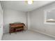 Bedroom with neutral carpet, a single window, white trim and baseboards, and a dark wood piano at 15207 W Ellsworth Pl, Golden, CO 80401