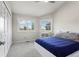 Bedroom features a bed with blue sheets, two windows, and a closet with sliding doors at 15207 W Ellsworth Pl, Golden, CO 80401