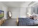 Cozy bedroom featuring plush bedding, closet storage, and a window offering natural light at 15207 W Ellsworth Pl, Golden, CO 80401