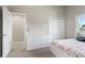 Bedroom with a bed, dresser, and closet in a neutral color palette at 15207 W Ellsworth Pl, Golden, CO 80401
