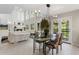 Elegant dining area with views of the fireplace, garden, and white decor at 15207 W Ellsworth Pl, Golden, CO 80401