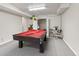Entertaining game room with pool table, neutral carpet, and a view to the living area at 15207 W Ellsworth Pl, Golden, CO 80401
