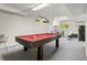 Spacious game room featuring a pool table with red felt, carpet flooring, and bright lighting for entertainment at 15207 W Ellsworth Pl, Golden, CO 80401