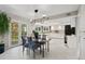 Bright kitchen with white cabinets, stainless steel appliances, and an eat-in dining area at 15207 W Ellsworth Pl, Golden, CO 80401