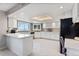 Bright kitchen featuring white cabinetry, modern appliances, and a skylight at 15207 W Ellsworth Pl, Golden, CO 80401