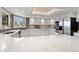 Bright kitchen featuring white cabinetry, modern appliances, and a skylight at 15207 W Ellsworth Pl, Golden, CO 80401