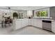 Modern kitchen with white cabinets, stainless steel appliances, and ample counter space at 15207 W Ellsworth Pl, Golden, CO 80401