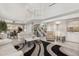 Spacious living room with a fireplace, staircase, and large windows providing natural light at 15207 W Ellsworth Pl, Golden, CO 80401