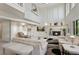 Bright, open living room featuring a fireplace and a two-story ceiling at 15207 W Ellsworth Pl, Golden, CO 80401